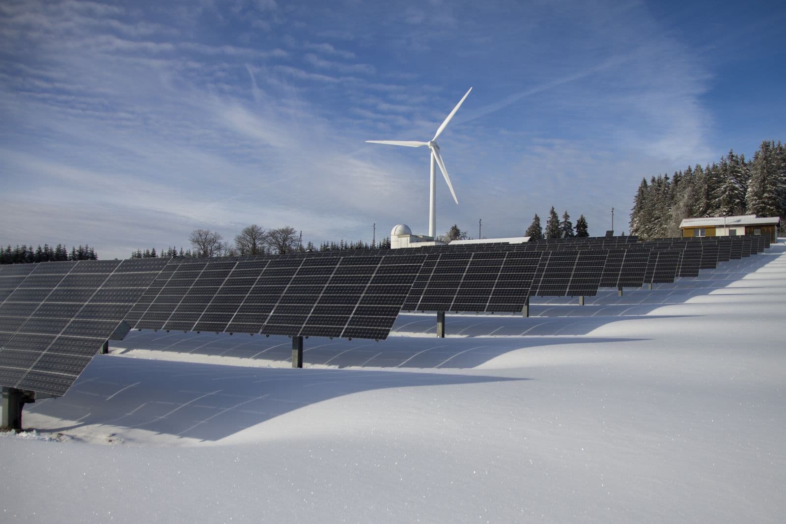 Rows of solar panels in a snowy landscape